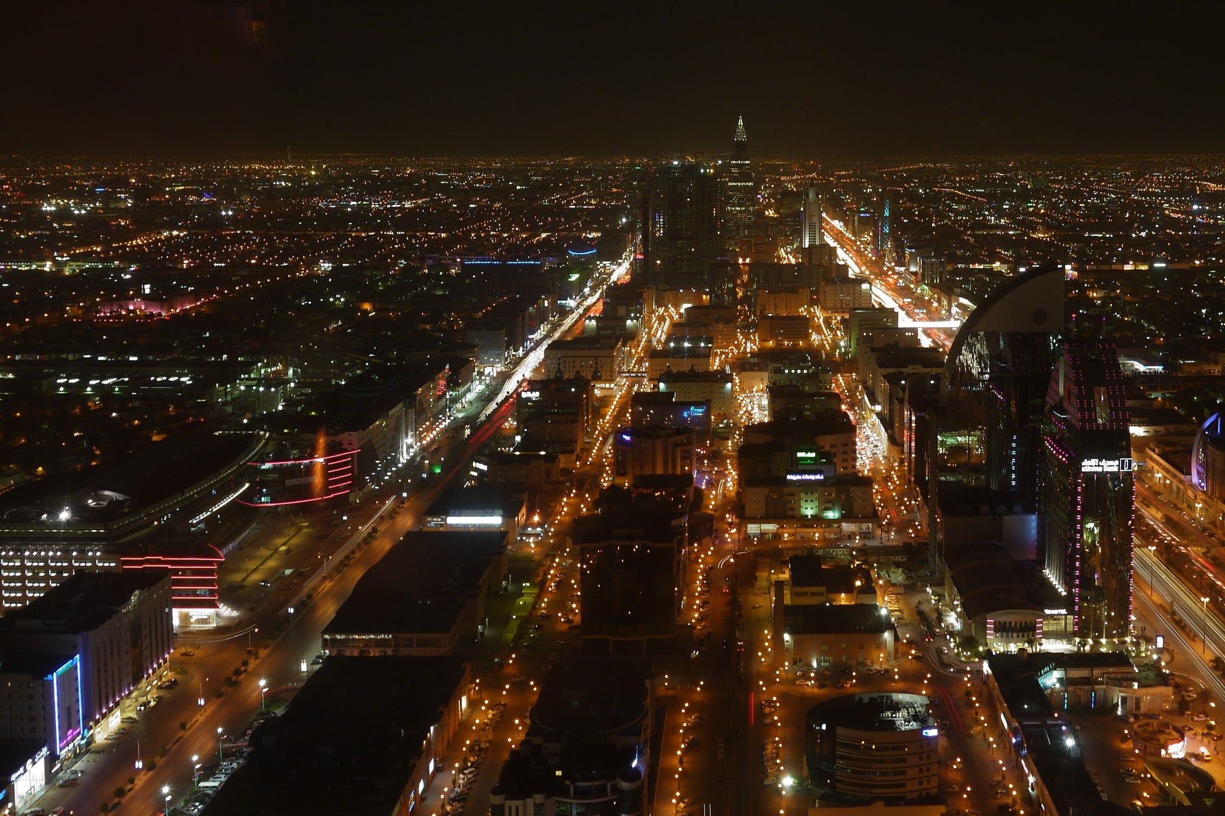 Riyadh at night, lit boulevards and towers across the Saudi capital.